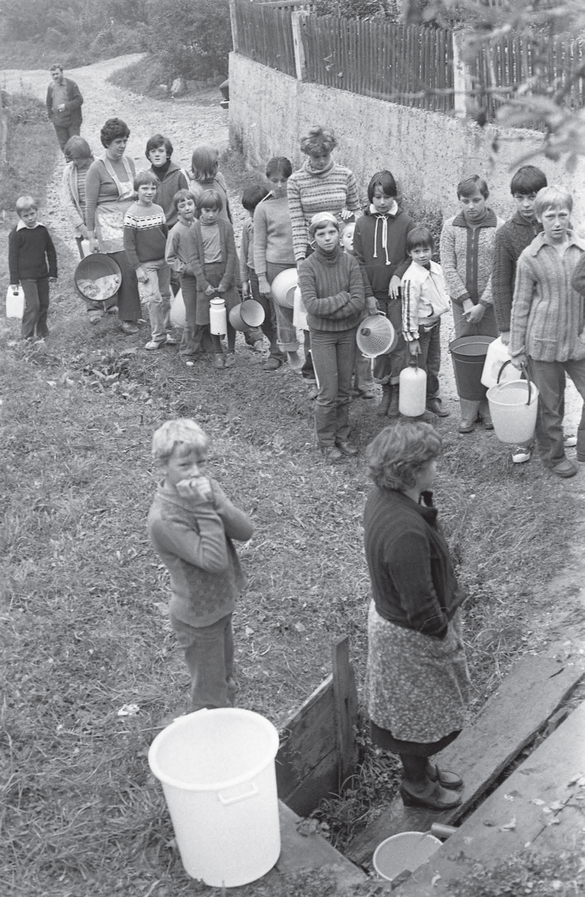 Waiting in line for water. Litija, October 1978. Photo by Svetozar Busić,
                        preserved by the National Museum of Contemporary History of Slovenia
                        (NMCHS).