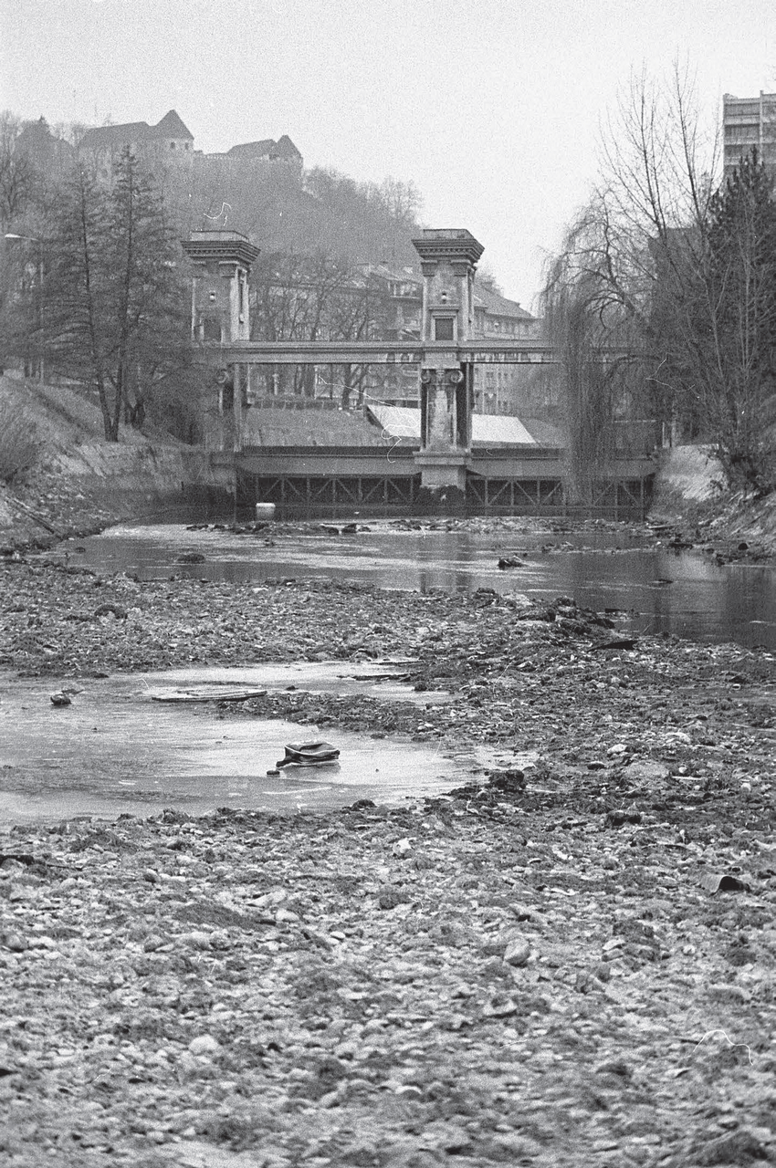 The dried-up Ljubljanica River. Ljubljana, November 1983. Photo by Miško
                        Kranjec, preserved by the National Museum of Contemporary History of
                        Slovenia (NMCHS).
